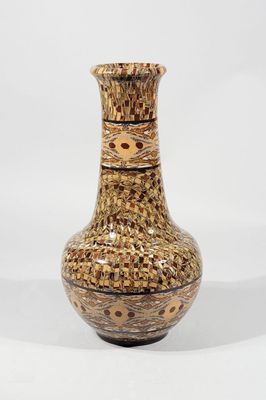 a brown vase that is sitting on a white surface