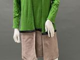 an image of a mannequin wearing a green top and tan shorts