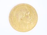 l'image d'une pièce d'or sur laquelle figure une tête de femme