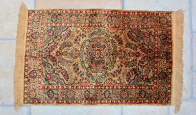 a close up of a rug on a tiled floor in a room