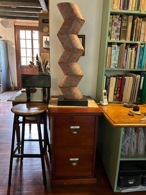 a desk with a chair and a lamp in a room