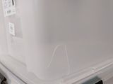 a large plastic box with a lid on the floor