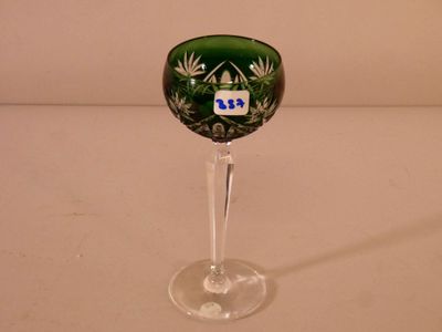 a wine glass with a green and white design on it