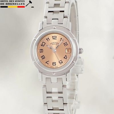 an image of a woman ' s wrist watch with a pink dial