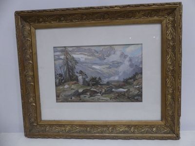 framed picture of a painting of a mountain scene in a gold frame on a white wall