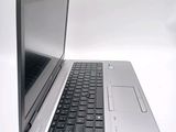 a silver laptop with a black keyboard on a white surface