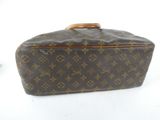 louis vuittoupe suitcase with wooden handle on white background