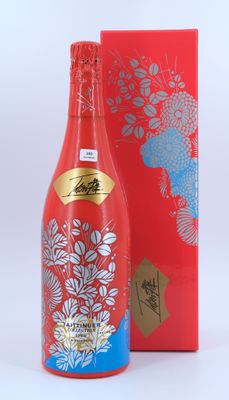 a bottle of red wine next to a red box
