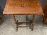 a small wooden table with a star design on it