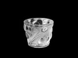 a glass cup that is sitting on a black surface