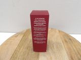an image of a bottle of red liquid on a wooden table