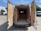 a white van that has its doors open in a parking lot