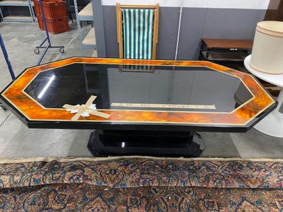 a table that has a glass top and a black base