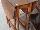 a small table with a drop leaf on it