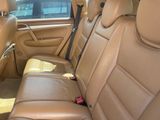 a tan leather car with a black seat belt
