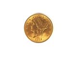 a close up of a gold coin on a white surface