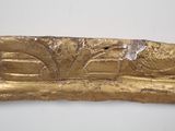 an image of a close up of a gold object on a white surface