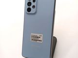 a close up of the back of a samsung galaxy s20 with a barcode sticker on the back of the phone