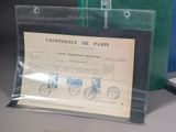 a picture of a green bag with stamps on it next to a pair of scissors