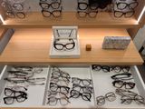 many pairs of glasses on display in a display case