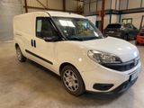the white van is parked in a garage with other cars in the background