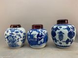 three blue and white vases sitting on top of a table