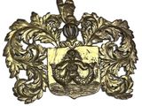 a close up of a gold plate with a coat of arms on it