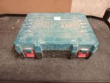 a blue case sitting on a table with red handles