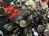 many different types of jewelry on a black table