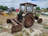 a tractor that is sitting in the dirt in the field