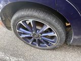 a close up of a tire on a blue car