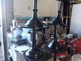 three black vases sitting on a table in a room