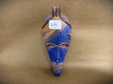 a blue and brown mask on a brown leather surface