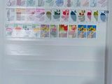 a refrigerator with stamps on it in the kitchen