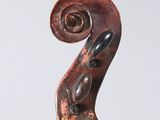 a close up of the back of a violin with a fiddle in the foreground