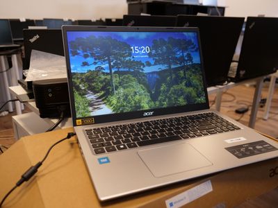 a laptop computer sitting on top of a box on a table