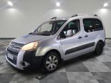 the silver van is parked on a checkered floor in the garage