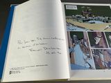 an open book with a picture of a baseball game on it