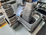 several trays of food are stacked on top of each other in a kitchen