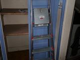 a ladder leaning against a blue door in a room