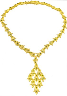 an image of a gold necklace with green stones on a white background