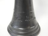 a bell that is sitting on a white surface