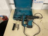 a blue tool box with a hammer and other tools on a table