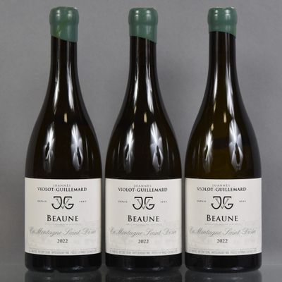 three bottles of wine are lined up on a table