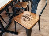 a wooden table with black chairs and a wooden table
