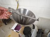 a person that is holding a bowl in a kitchen