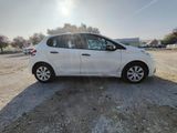 a white car parked in a parking lot with the sun shining on it