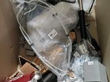 a cardboard box filled with items that include a baby stroller and other items