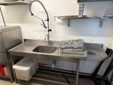 a kitchen with a sink and a dishwasher in it