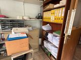 a closet full of files and boxes in a room